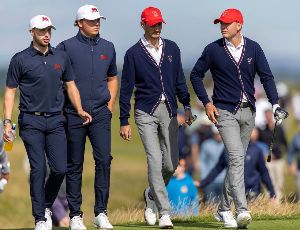 Alex Maguire, left, and James Ashfield of Great Britain and Ireland walk with Nick Gabrelcik...