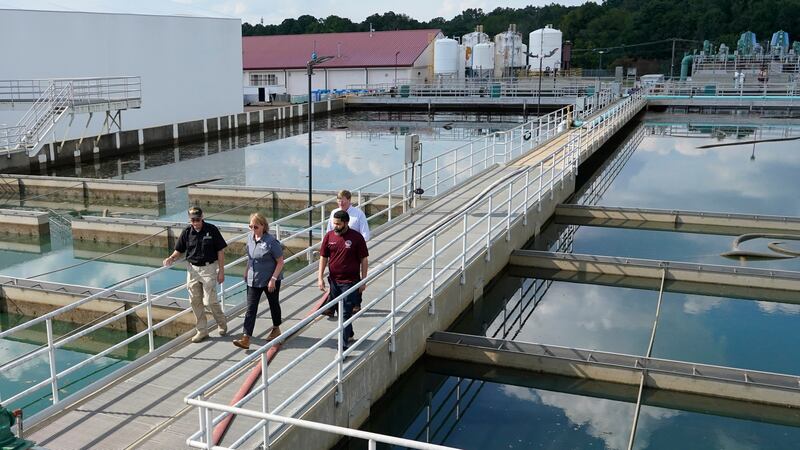 Jim Craig, with the Mississippi State Department of Health, left, leads Jackson Mayor Chokwe...